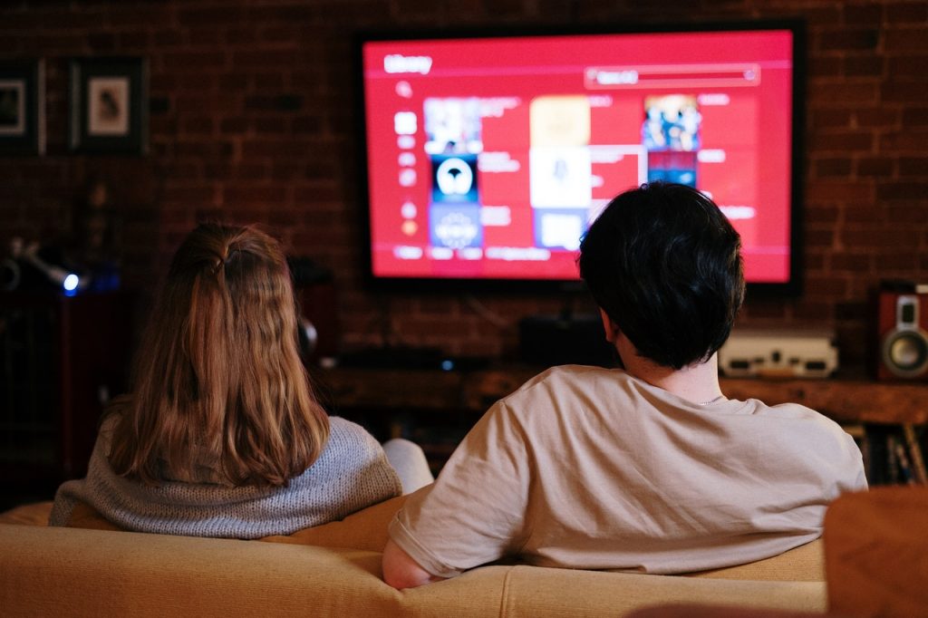 couple watching a streaming service on their couch